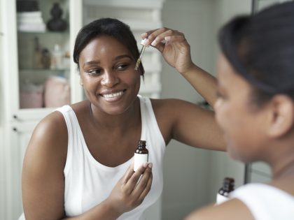 african american woman using serum to face in the 2024 12 04 09 47 16 utc